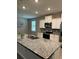 Kitchen island with granite countertop and double sink at 17926 Hither Hills Cir, Winter Garden, FL 34787