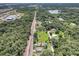 Aerial view of a single-Gathering home with a large backyard and surrounding trees at 702 S Myrtle Ave, New Smyrna Beach, FL 32168