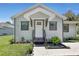 Modern home with gray siding, white door and landscaping at 702 S Myrtle Ave, New Smyrna Beach, FL 32168