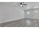 Spacious living room with grey floors and ceiling fan at 702 S Myrtle Ave, New Smyrna Beach, FL 32168