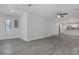 Open living area with kitchen access and wood-look floors at 702 S Myrtle Ave, New Smyrna Beach, FL 32168