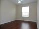 Spacious bedroom with hardwood floors and large window at 6214 Stevenson Dr # 201, Orlando, FL 32835
