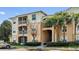 Condo building with palm trees and parking at 6214 Stevenson Dr # 201, Orlando, FL 32835