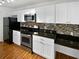 Modern kitchen with stainless steel appliances and white cabinets at 4350 Perkinshire Ln # 111, Orlando, FL 32822