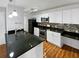 Modern kitchen with white cabinets, granite countertops, and stainless steel appliances at 4350 Perkinshire Ln # 111, Orlando, FL 32822