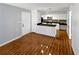 Open concept living area with hardwood floors and white kitchen at 4350 Perkinshire Ln # 111, Orlando, FL 32822