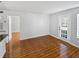 Living room with wood-look tile floors and access to other rooms at 4350 Perkinshire Ln # 111, Orlando, FL 32822
