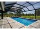Enjoy the view from under this screened pool enclosure at 17694 Sw 61St Lane Rd, Dunnellon, FL 34432