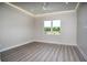 Light and airy bedroom featuring wood-look floors and a ceiling fan at 17694 Sw 61St Lane Rd, Dunnellon, FL 34432