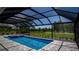Relaxing pool and spa with screened enclosure and golf course view at 17694 Sw 61St Lane Rd, Dunnellon, FL 34432
