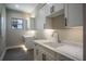 Bright laundry room with white cabinets and marble countertops at 17694 Sw 61St Lane Rd, Dunnellon, FL 34432