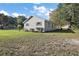 Side view of the house showcasing its light-colored siding and landscaping at 2805 Nw 4Th Ave, Ocala, FL 34475