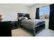 Cozy bedroom with black bed frame and patterned bedding at 1157 Torrente Ln, Haines City, FL 33844