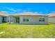 House exterior and grassy backyard at 1157 Torrente Ln, Haines City, FL 33844
