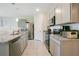 Modern kitchen with stainless steel appliances and granite countertops at 1157 Torrente Ln, Haines City, FL 33844