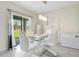 Bright dining room with glass table and view of backyard at 1157 Torrente Ln, Haines City, FL 33844