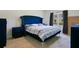 Spacious bedroom with a blue velvet bed and nightstands at 1157 Torrente Ln, Haines City, FL 33844
