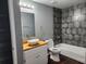 Updated bathroom with a bathtub, stylish tile, and a wood countertop at 645 W 6Th St, Lakeland, FL 33805
