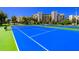 Two well-maintained blue tennis courts with green boundary lines at 5300 S Atlantic Ave # 15-403, New Smyrna Beach, FL 32169