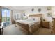 Bright bedroom with king-size bed and access to a private balcony at 5300 S Atlantic Ave # 15-403, New Smyrna Beach, FL 32169
