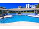 Inviting community pool with surrounding patio and clubhouse at 5300 S Atlantic Ave # 15-403, New Smyrna Beach, FL 32169