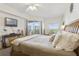 Spacious bedroom with a king-size bed, balcony access, and ocean views at 5300 S Atlantic Ave # 15-403, New Smyrna Beach, FL 32169