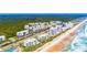 Aerial view of community, showcasing beach access and lush landscaping at 5300 S Atlantic Ave # 15-403, New Smyrna Beach, FL 32169