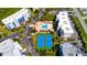 Aerial view showing tennis courts and pool, near community buildings at 5300 S Atlantic Ave # 15-403, New Smyrna Beach, FL 32169