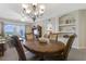 Elegant dining room features a chandelier and hardwood table at 5300 S Atlantic Ave # 15-403, New Smyrna Beach, FL 32169