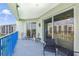 Relaxing balcony with sliding glass doors and wicker furniture at 5300 S Atlantic Ave # 15-403, New Smyrna Beach, FL 32169