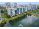 Aerial view of waterfront community with lush landscaping and a pond at 5300 S Atlantic Ave # 15-403, New Smyrna Beach, FL 32169