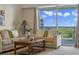Living room with comfortable seating and a view from the sliding doors at 5300 S Atlantic Ave # 15-403, New Smyrna Beach, FL 32169