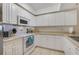 Clean and efficient kitchen featuring white cabinetry and stainless steel appliances at 5300 S Atlantic Ave # 15-403, New Smyrna Beach, FL 32169
