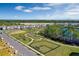 Aerial view of houses, park, lake, and walking paths in a new community at 16217 Honey Harvest St, Winter Garden, FL 34787