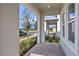 Covered front porch with brick flooring and view of neighborhood at 16217 Honey Harvest St, Winter Garden, FL 34787