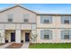 Two-story townhome with light gray and beige siding at 3982 Lana Ave, Davenport, FL 33897