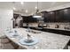 Kitchen island with seating, granite countertops, and dark brown cabinets at 3982 Lana Ave, Davenport, FL 33897