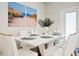 Bright dining room with white table and chairs, beach-themed artwork at 3982 Lana Ave, Davenport, FL 33897