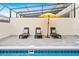 Inviting pool area with lounge chairs and umbrella at 3982 Lana Ave, Davenport, FL 33897