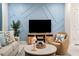 Living room with sectional sofa, accent chair, coffee table, and a geometric accent wall at 3982 Lana Ave, Davenport, FL 33897
