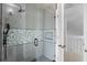 Updated shower with pebble tile accent and glass enclosure at 2715 Autumn Green Dr, Orlando, FL 32822
