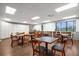 Community game room with tables, chairs, and bookshelves at 2715 Autumn Green Dr, Orlando, FL 32822