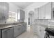 Modern kitchen with granite countertops and gray cabinets at 2715 Autumn Green Dr, Orlando, FL 32822