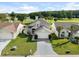 Two-story house with gray siding, white garage door, and manicured lawn, near golf course at 2715 Autumn Green Dr, Orlando, FL 32822