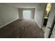 Spacious bedroom with plush carpeting and access to a private balcony at 6003 Village Cir # Ge, Orlando, FL 32822