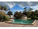 Community pool with surrounding landscaping at 6003 Village Cir # Ge, Orlando, FL 32822