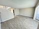 Bright and airy living room with gray tile flooring and a staircase at 6003 Village Cir # Ge, Orlando, FL 32822