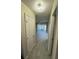 Clean hallway with tile flooring and access to living areas at 6003 Village Cir # Ge, Orlando, FL 32822
