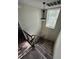 Carpeted staircase leading to upper level with window and light at 6003 Village Cir # Ge, Orlando, FL 32822