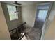 Carpeted staircase with metal railing and light fixture at 6003 Village Cir # Ge, Orlando, FL 32822